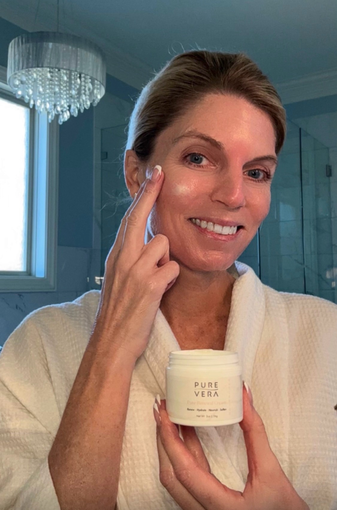 Jennifer demonstrating a Pure Vera skincare product