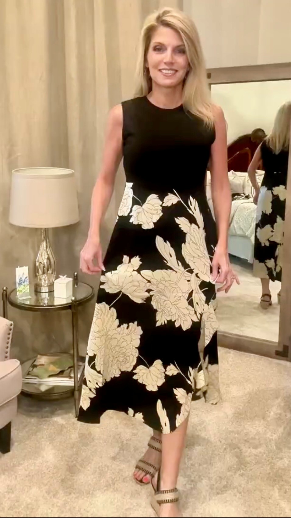 Jennifer modeling a black and ivory floral dress